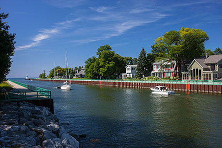 sunny afternoon, cottages and boats on Pentwater channel to Lake Michigan