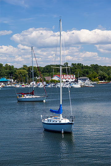sunny day, two sailboats docked in the harbor